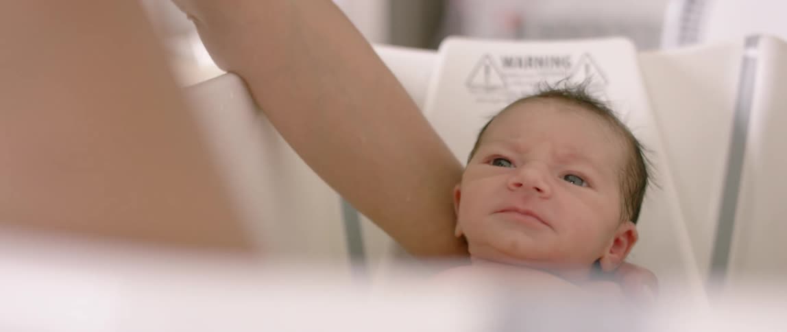 A newborn is given a bath