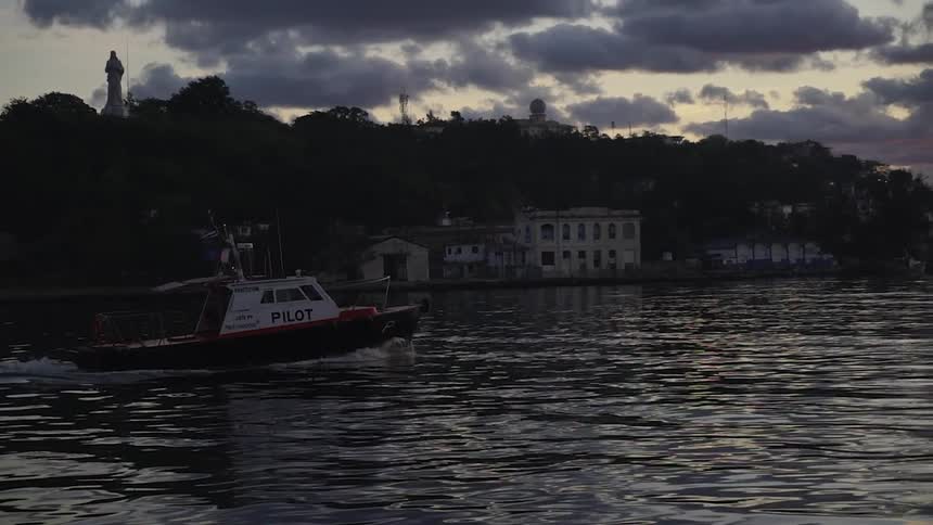 A boat is sailing slowly in the water