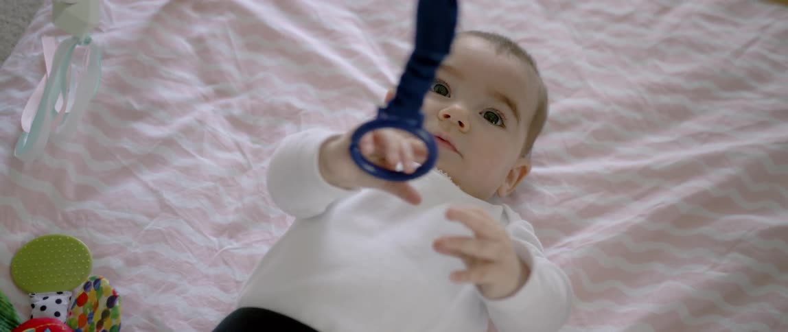 A baby is laying down in a crib