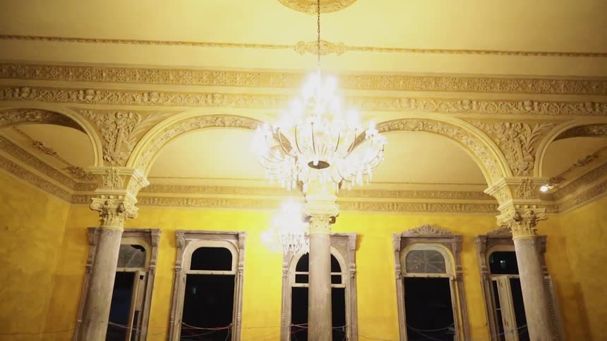 The hall has a chandelier down the hall