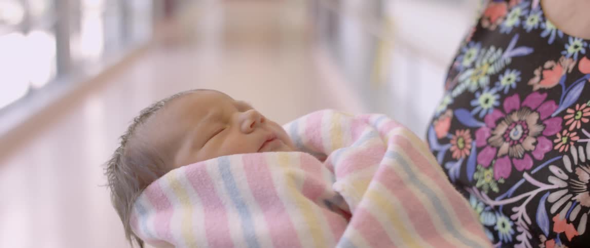 Person holds a sleeping infant