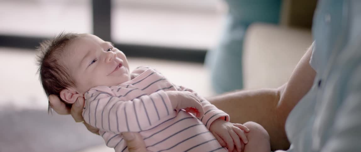A man holds a newborn