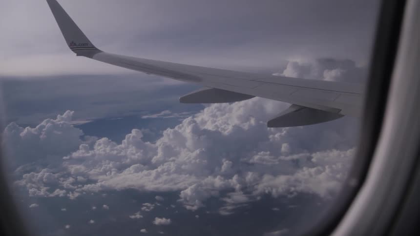 View looking out the window of an airplane over the clouds