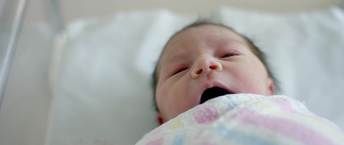 A newborn opens its mouth and yawns