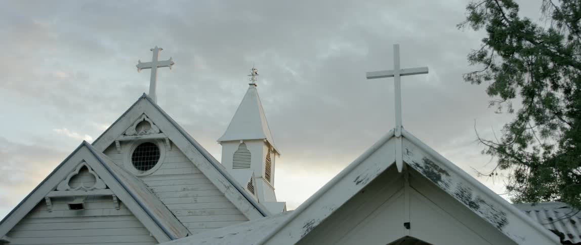 Clouds float over a small church