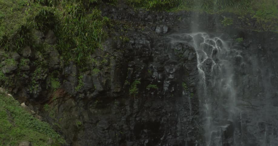 A waterfall cascades over a rocky cliff
