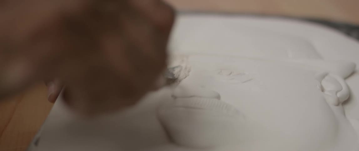 A tool is used to to make a sculpture in plaster