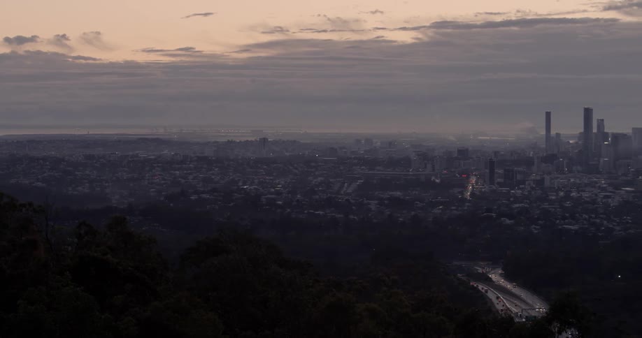 The city below has heavy clouds above