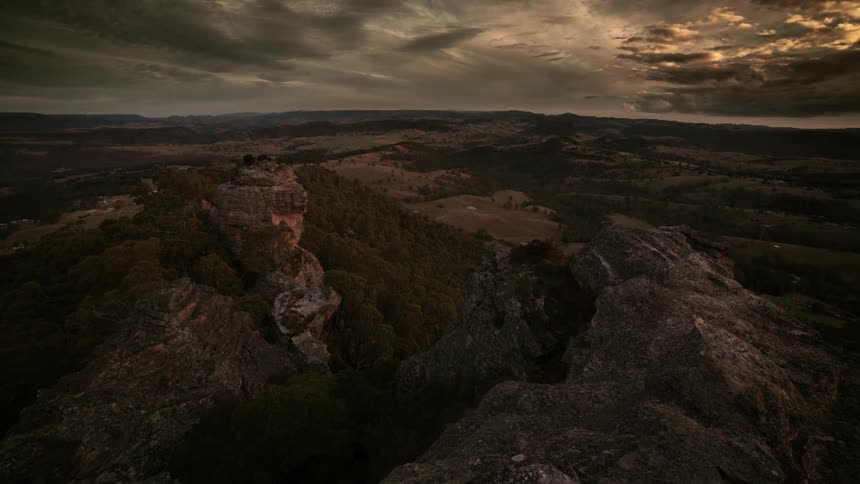 The sun goes down as clouds drift over the land