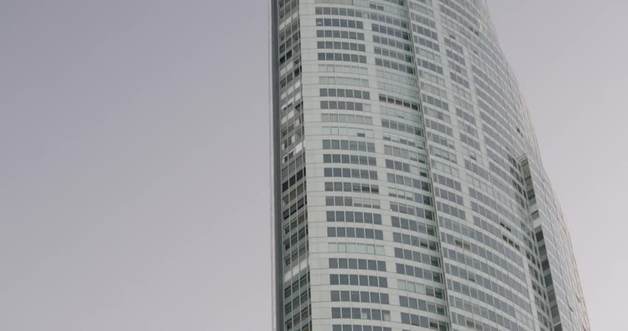A large building with a lot of windows on a cloudy day