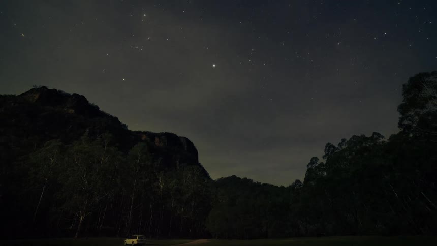 A timelapse of a landscape at night is displayed