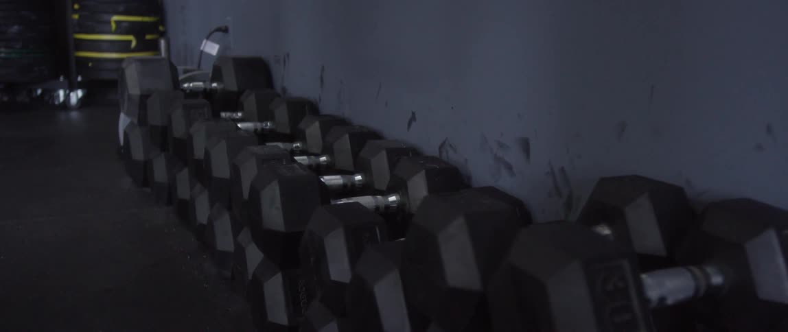 Barbells line the wall