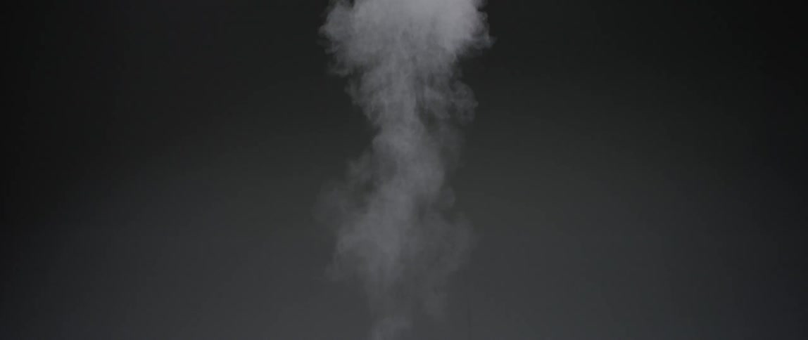 A projectile flies leaving a trail of smoke