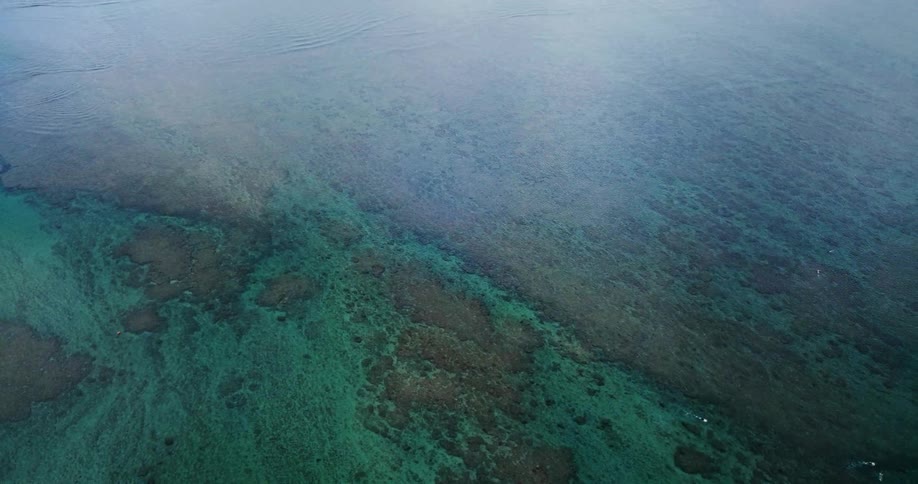 The water is still below with rocks at the bottom of the clear water