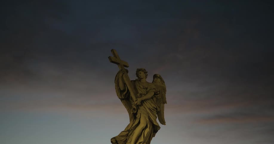 Statue of person holding a cross