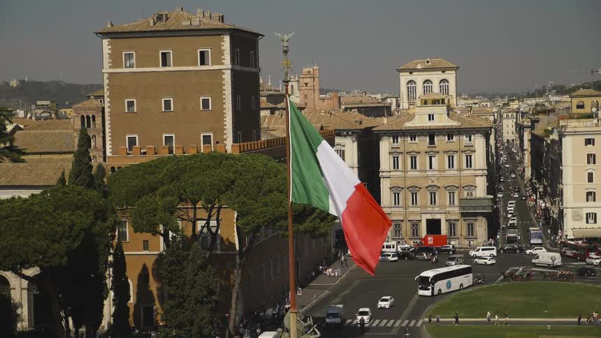 Flag standing high in a city