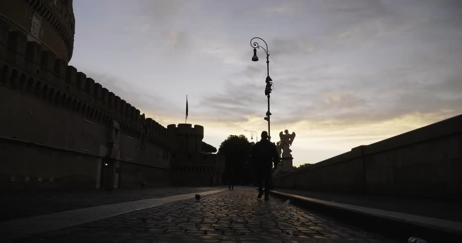 A man walks down the cobblestone path