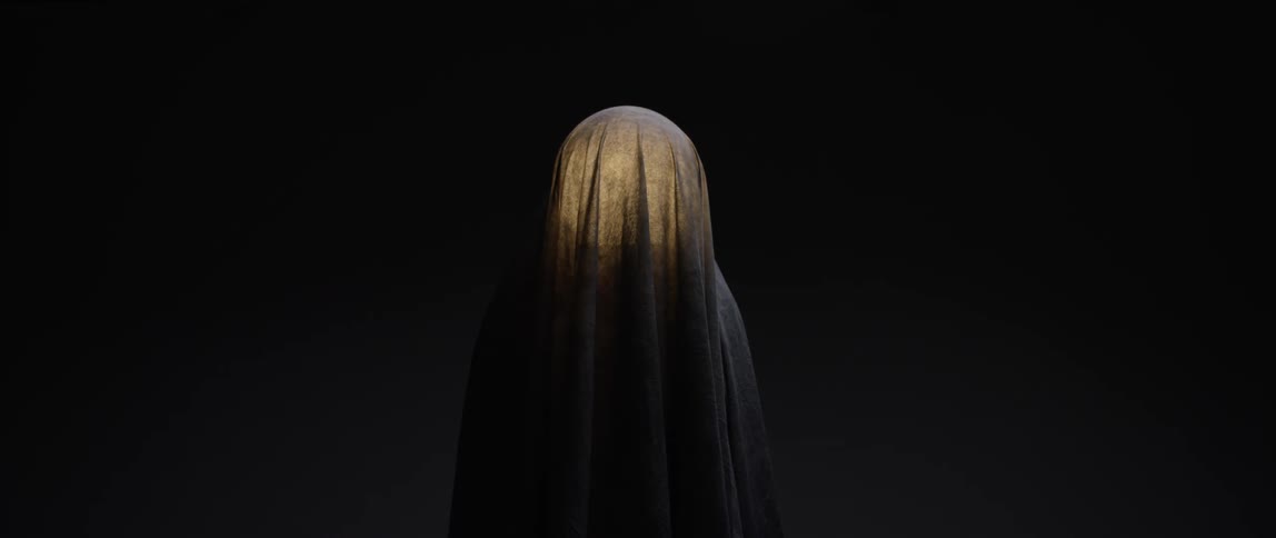 A sheet covering something in a dark area gets a spotlight
