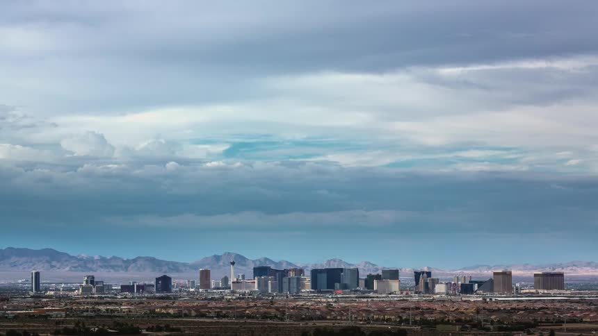Clouds move over a city skyline