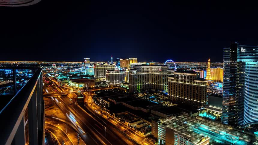 A balcony view of the traffic and lights of a city at night