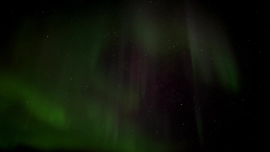Green waving northern lights at night