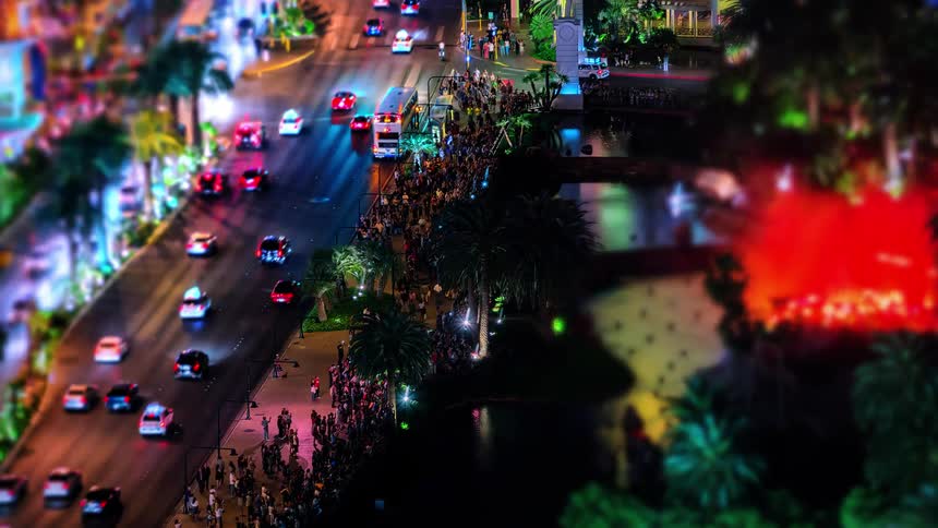A busy city street with cars and pedestrians at night