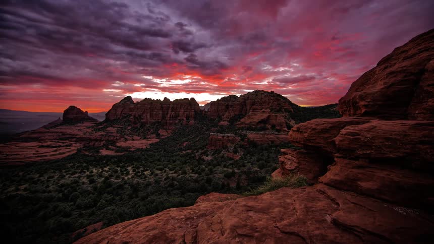 The sun sets over a desert landscape
