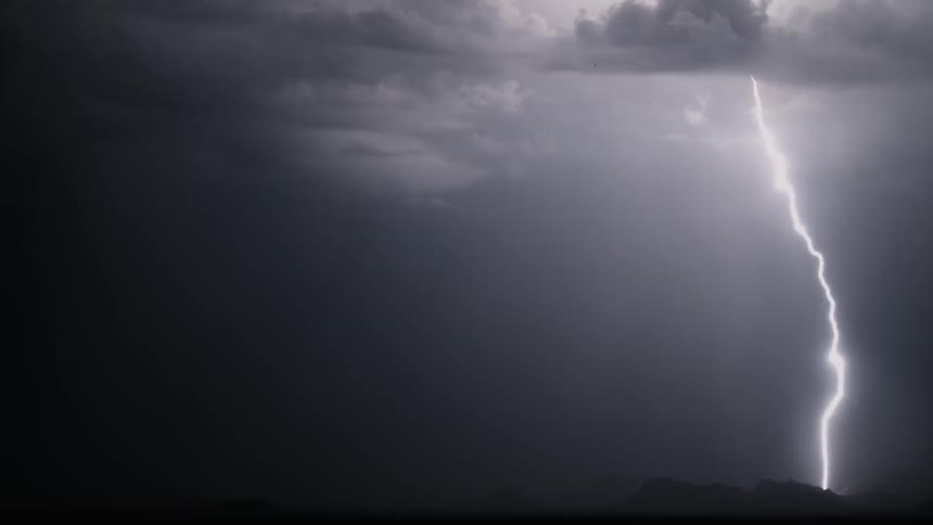 Lightning flashes in the dark night sky
