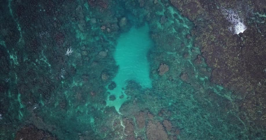 Clear water showing rocks on the ocean floor