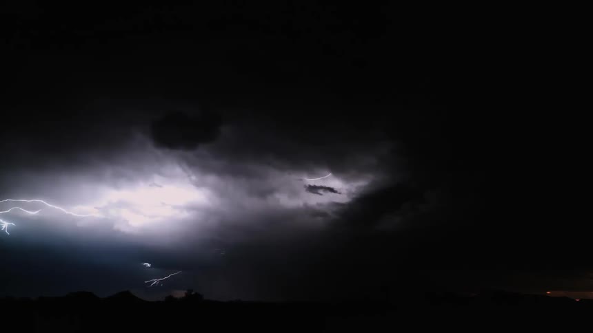 The night clouds light up with flash lightning