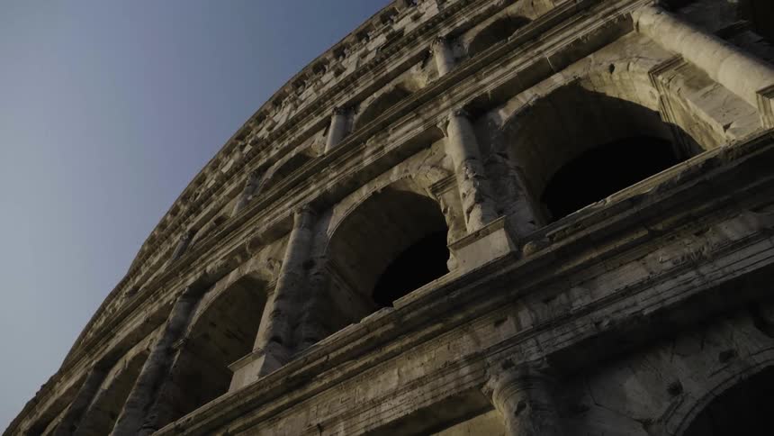 A colosseum has many floors with pillars and arches