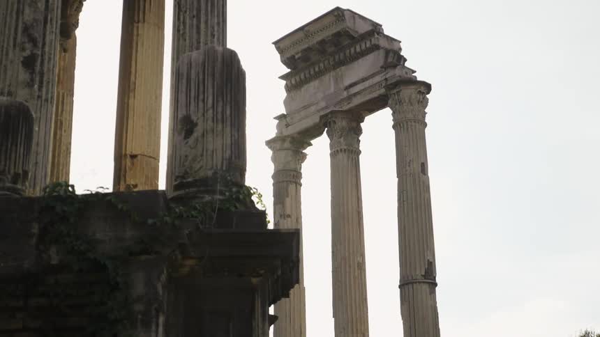 Stone pillars are run down with heavy clouds above