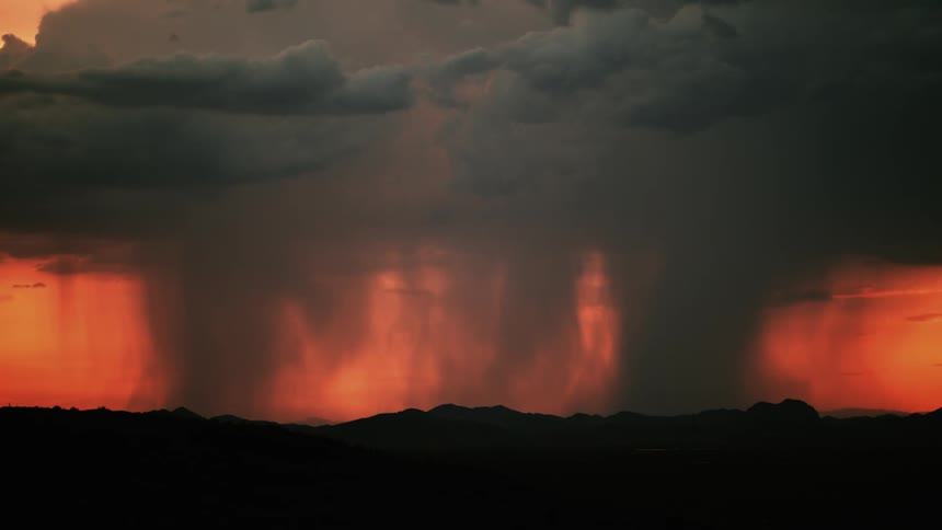 Lightning flashes during a rainstorm at sunset