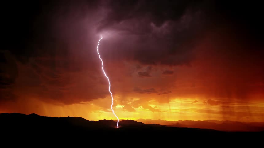 Lightning is flashing across the sky in the distance