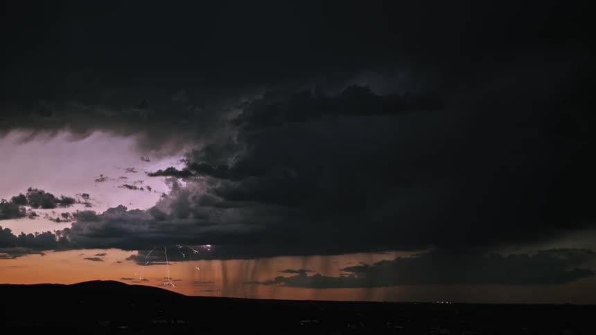 Lightning flashes during a storm at sunset