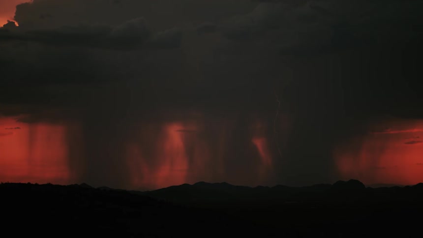 Lightning flashes during a storm at sunset