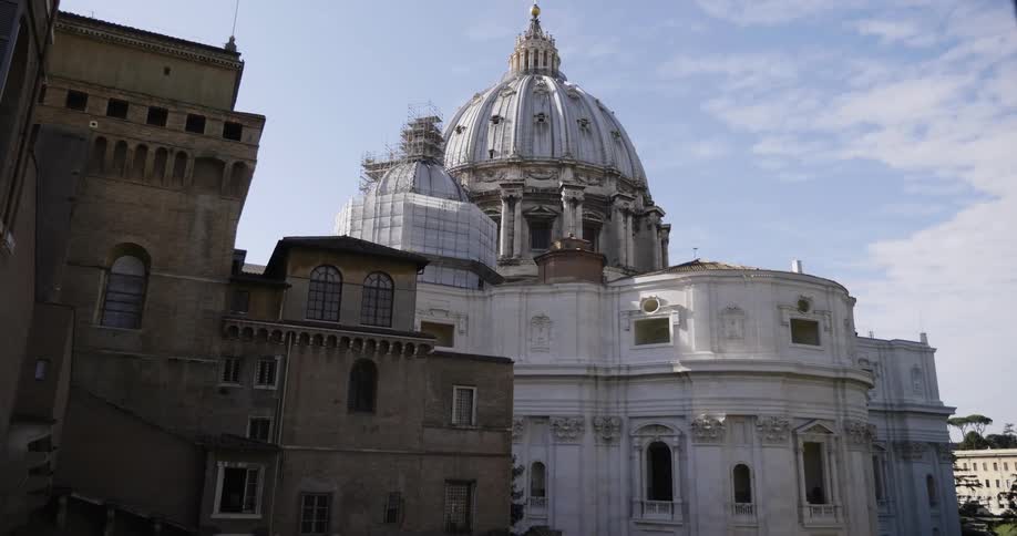 Clouds float near a domed city building