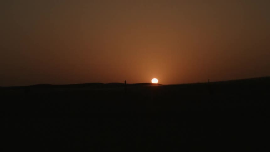 The sun sets over the horizon