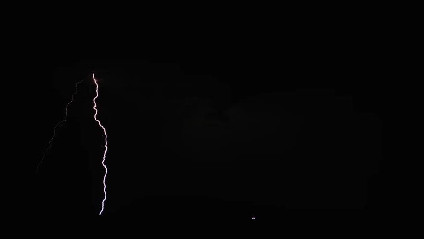 Lightning snakes down from the sky at night