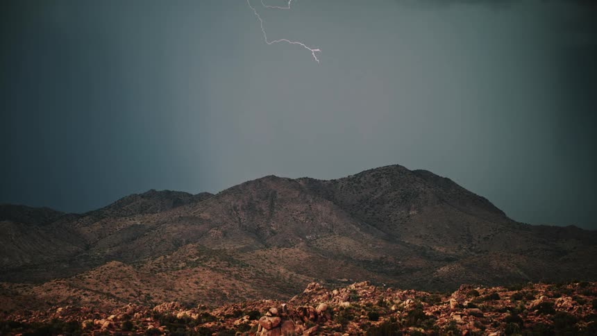 Lightning flashes over a mountain