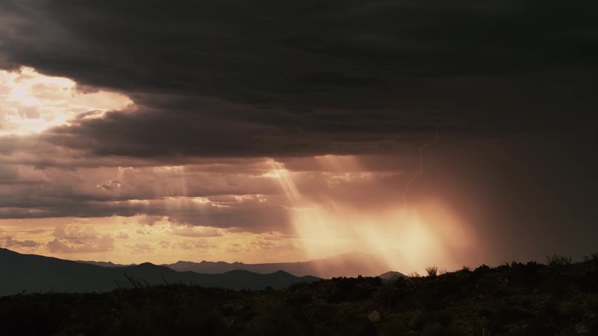 Sun shining through clouds as lightning strikes