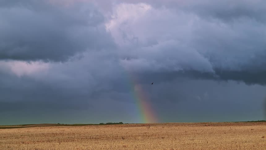 Rainbow among clouds on the plains
