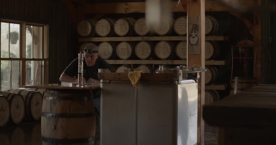 A man sits at a table in the distillery