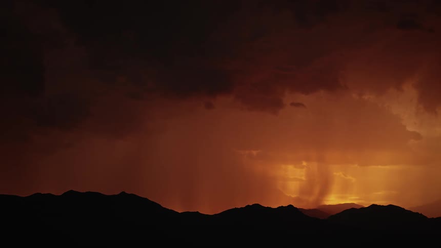 Lightning strikes a hill at sunset