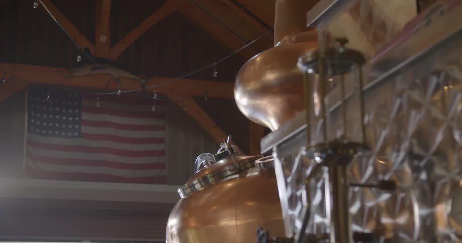 An american flag is on the wall of this distillery warehouse