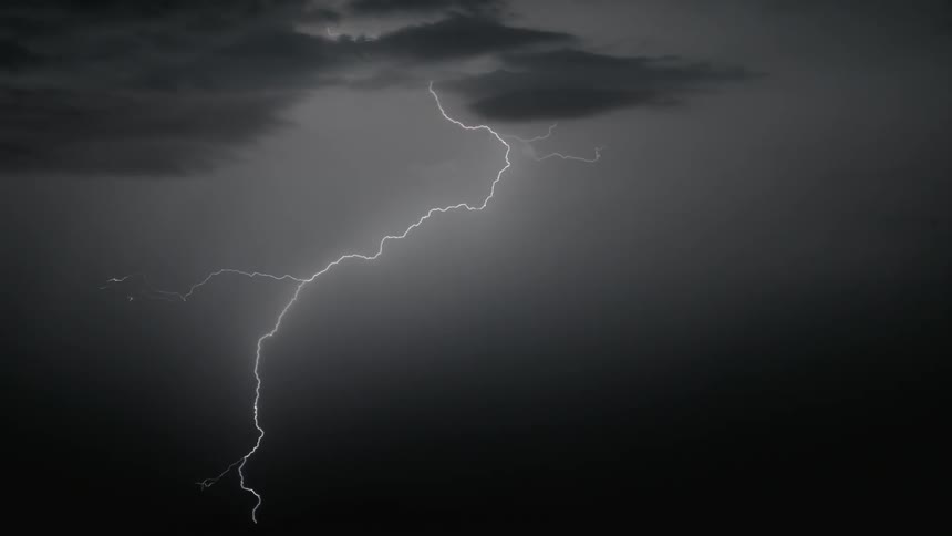 Lightning snakes down from the sky at night