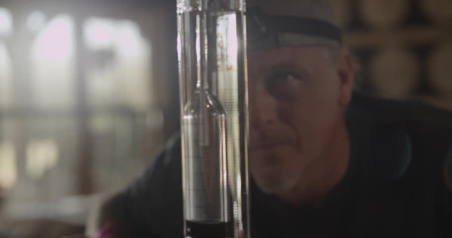 A man checks a measurement vial