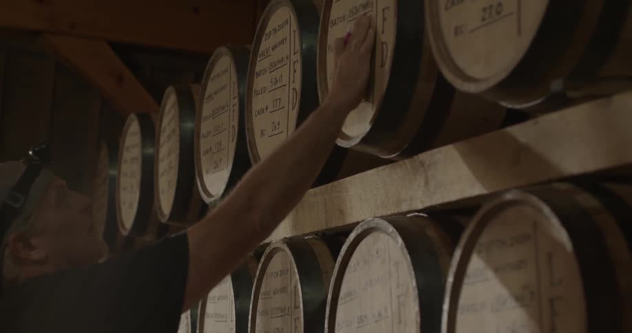 A man is looking at pad while checking barrels