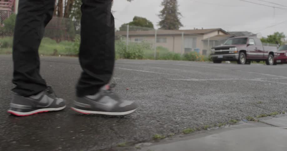 Man walking down a street on a cloudy day
