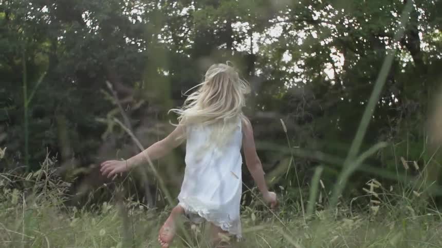 Girl running through grass